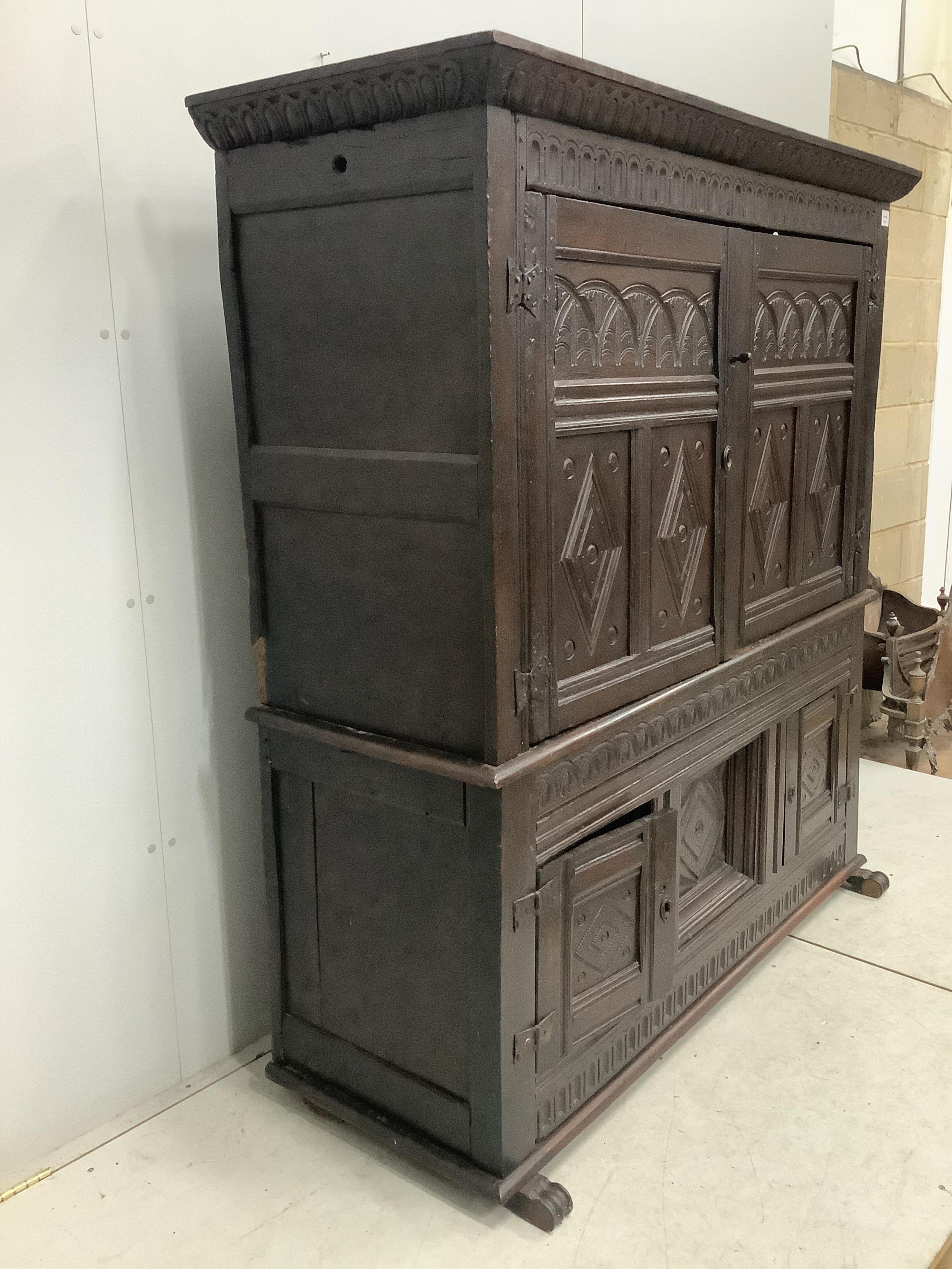 A late 17th century Continental carved oak two section cupboard, width 166cm, depth 57cm, height 167cm. Condition - fair